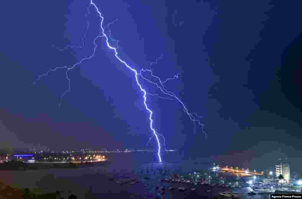 A lightning bolt strikes near the Uruguayan Yacht Club during a thunderstorm in Montevideo.