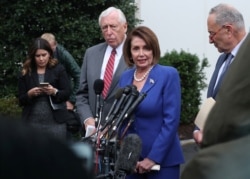 U.S. House Speaker Nancy Pelosi (D-CA) walks out with Senate Minority Leader Chuck Schumer (D-NY) and House Majority Leader Steny Hoyer (D-MD) to speak with reporters after meeting with President Trump at the White House in Washington, Oct. 16, 2019.