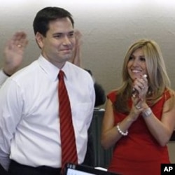 Republican Florida Senator-elect Marco Rubio and his wife Jeanette smile as national TV stations call the race in his favor while watching results in Coral Gables, Florida, 2 Nov. 2010