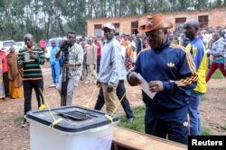FILE - Burundi President Pierre Nkurunziza casts his ballot at a polling center during the constitutional amendment referendum at School Ecofo de Buye in Mwumba commune in Ngozi province, northern Burundi, May 17, 2018.