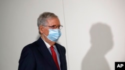 Senate Majority Leader Mitch McConnell wears a face mask used to protect against the spread of the new coronavirus as he attends a press conference after meeting with Senate Republicans at their weekly luncheon on Capitol Hill in Washington, May 19, 2020.