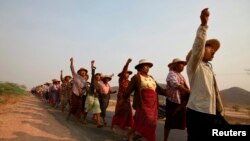 FILE - Villagers rally against land seizures for a copper mine project at Lapdaung Hill, in Sarlingyi township, Myanmar, March 13, 2013.