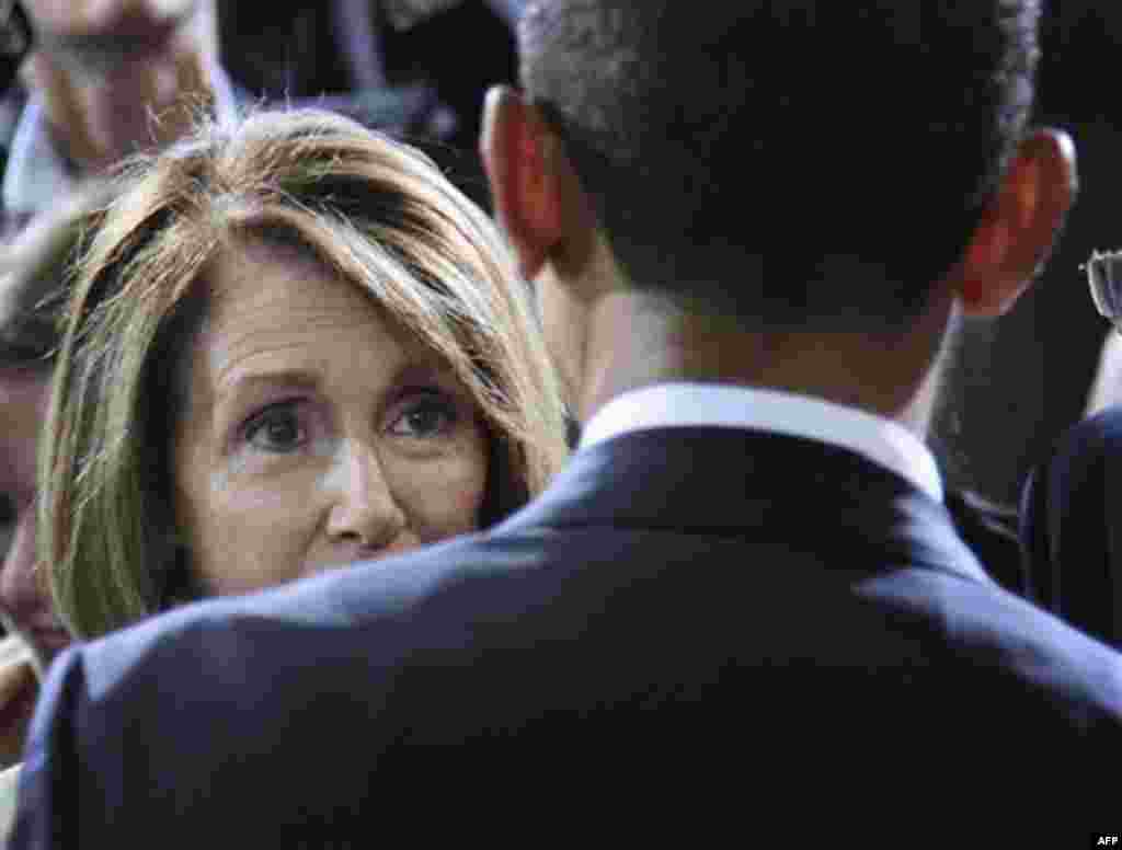 President Barack Obama speaks with House Minority Leader Nancy Pelosi of Calif., at the Washington Convention Center in Washington, Friday, July 29, 2011, after delivering remarks on improved Fuel Efficiency Standards for cars and light trucks. (AP Photo