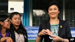 FILE - Thai Prime Minister and Pheu Thai party leader Yingluck Shinawatra poses before casting her ballot in Bangkok, Feb. 2, 2014.