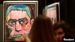 FILE - A painting by David Bowie is set up for the the David Bowie exhibition in Berlin, Germany, May 14, 2014.
