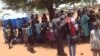 South Sudanese who fled fighting in their country wait in line to be registered as refugees in Uganda in March 2014. Some refugees in Uganda have spoken out against plans by the Juba government to hold elections in June 2015.