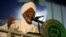 FILE - Islamist opposition leader Hassan al-Turabi gives a speech during the general conference of the ruling National Congress Party in Khartoum, Oct. 23, 2014. Prominent politician, 84, died on March. 5, 2016, of a heart attack.