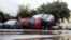 Damaged cars are pictured the day after floods hit the town of Trebes, southern France, Tuesday, Oct. 16, 2018. French officials say flash floods that swept through the southwest Aude region largely claimed elderly victims, who were seemingly caught off guard by the sudden torrents.