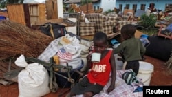 Zimbabwean children sit among salvaged possessions at a transit camp for over 100 families displaced by floods near the Tokwe-Mukorsi dam about 430km (267 miles) south of Harare, Feb. 13, 2014.