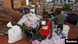 Zimbabwean children sit among salvaged possessions at a transit camp for over 100 families displaced by floods near the Tokwe-Mukorsi dam about 430km (267 miles) south of Harare, Feb. 13, 2014.