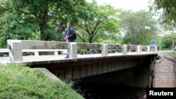 A man walks on the San Isidro bridge, after an anti-government group tried to destroy it the previous night, in Corinto, Nicaragua, Sept. 22, 2019. 