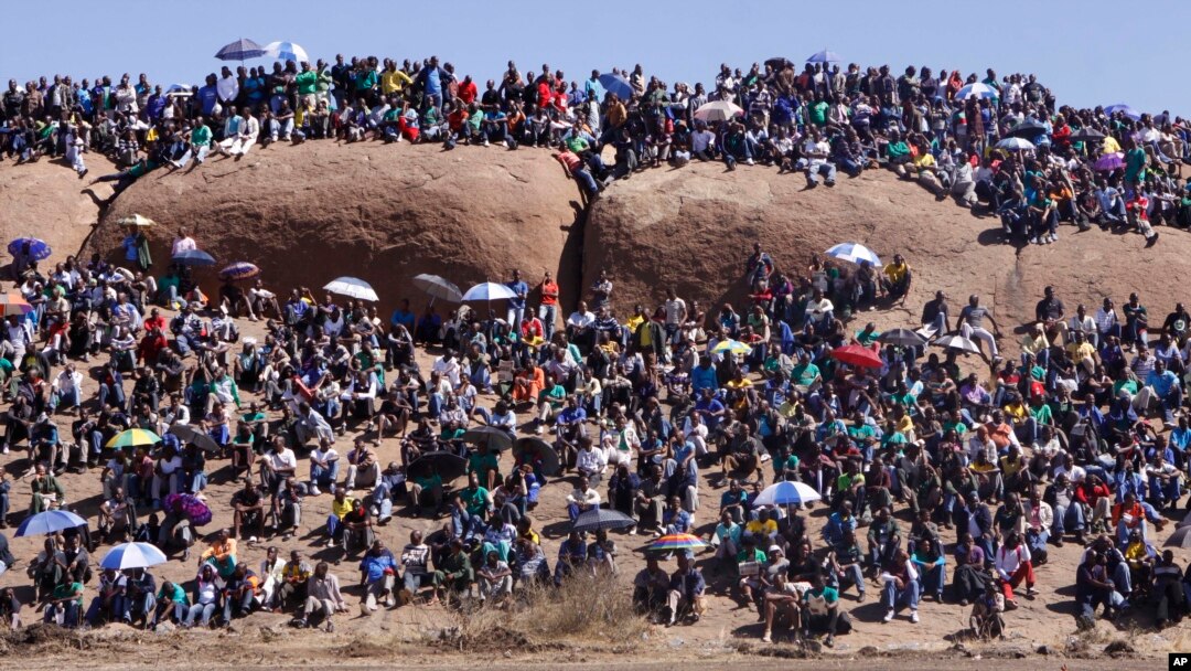 Warga menghadiri kebaktian untuk mengenang para penambang yang tewas dalam aksi mogok menuntut kenaikan upah setahun yang lalu di Marikana, Afrika Selatan (16/8).