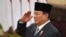 Indonesian President Prabowo Subianto salutes during the swearing-in ceremony of the new cabinet ministers at the presidential palace in Jakarta, Indonesia, Oct. 21, 2024.