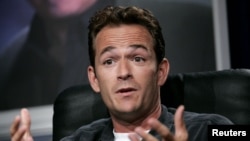 FILE - Actor Luke Perry reacts at the panel for Hallmark channel's "Supernova" show during the Television Critic's Association Summer press tour at the Beverly Hilton Hotel, Beverly Hills, July 16, 2005.