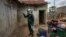 FILE - A worker of sprays the walls of a house with insecticide against mosquitoes, in Ghana, May 2, 2018.