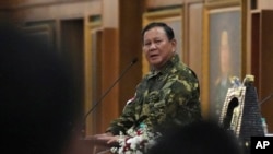 FILE - Indonesian President Prabowo Subianto delivers a speech before dinner during a cabinet retreat at the Military Academy in Magelang, Central Java, Indonesia, Oct. 25, 2024.