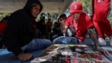 People play poleana, a board game invented in prison, before a tournament in Mexico City, Sunday, Nov. 17, 2024. (AP Photo/Ginnette Riquelme)