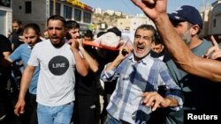 Mourners carry a body during the funeral of Palestinians who were killed in an airstrike during an Israeli raid, in Tubas in the Israeli-occupied West Bank, Sept. 13, 2024. 