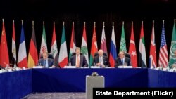 U.S. Secretary of State John Kerry sits with Russian Foreign Minister Sergey Lavrov, United Nations Special Envoy for Syria Staffan de Mistura, and United Nations Deputy Secretary-General Jan Eliasson on Feb. 11, 2016, at the Hilton Hotel join Munich, Ger