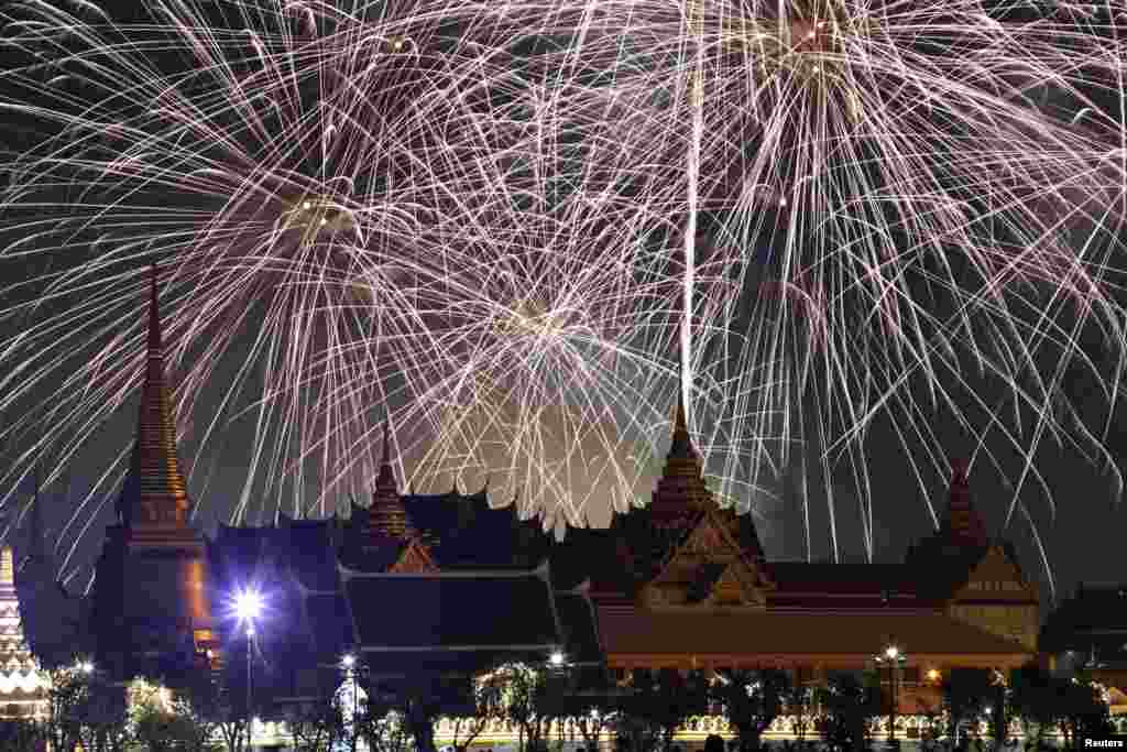 Thailand celebrates the New Year Eve with fireworks over riverside