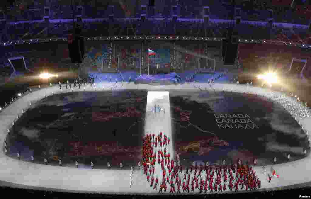 OlympicsA map of Canada is projected onto the stadium floor as athletes march in during the opening ceremony of the 2014 Sochi Winter Olympics, Feb. 7, 2014.