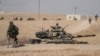 FILE - FILE - Turkish tanks and troops are deployed near the Syrian town of Manbij, Syria, Oct. 15, 2019. The area continues to experience violence, with Turkish-backed factions clashing with U.S.-backed Kurdish-led Syrian Democratic Forces.