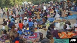 Cameroonian refugees who fled the violence that broke out in the border village of Ouloumsa in a dispute between herders, fishermen and farmers over dwindling water resources gather in N'Djamena, Chad, Dec. 10, 2021.