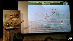 FILE - Pakistani army spokesman Lt Gen. Asim Bajwa briefs the media regarding the Torkham Border Terminal construction on the Pakistan-Afghan border crossing during a press conference in Rawalpindi, June 15, 2016. 