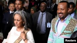 Ethiopia's Prime Minister Abiy Ahmed walks with newly-elected President Sahle-Work Zewde, as they leave the parliament building in Addis Ababa, Ethiopia, Oct. 25, 2018.