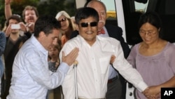 Blind Chinese legal activist Chen Guangcheng arrives at Washington Square Village on the campus of New York University, May 19, 2012, in New York.