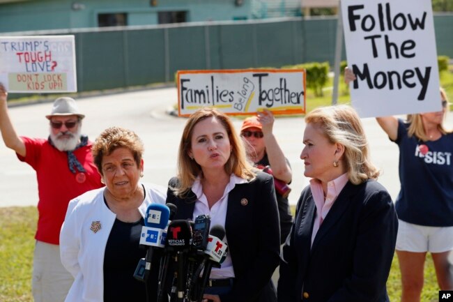 Rep. Debbie Mucarsel-Powell, D-Fla., center, speaks to members of the media about her tour of the Homestead Temporary Shelter for Unaccompanied Children, as Rep. Donna Shalala, D-Fla., left, and Rep. Sylvia Garcia, D-Texas, right, look on, in Homestead, Fla., Feb. 19, 2019.