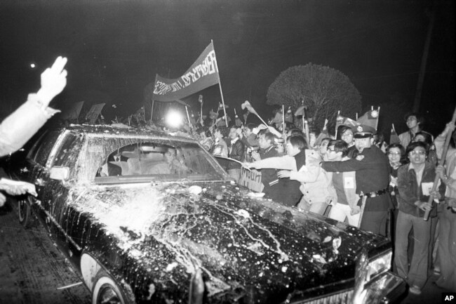 历史照片：因美台断交而愤怒的台湾示威者冲击从华盛顿抵达台北的美国代表团成员乘坐的黑色轿车。(1978年12月28日)