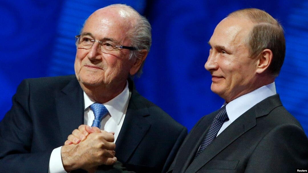FIFA's President Sepp Blatter shakes hands with Russia's President Vladimir Putin (R) during the preliminary draw for the 2018 FIFA World Cup at Konstantin Palace in St. Petersburg, July 25, 2015.