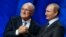 FILE - Now suspended FIFA President Sepp Blatter (L) shakes hands with Russian President Vladimir Putin during the preliminary draw for the 2018 FIFA World Cup at Konstantin Palace in St. Petersburg, July 25, 2015.