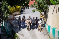 Security forces investigate the perimeters of the residence of Haitian President Jovenel Moise, in Port-au-Prince, Haiti, July 7, 2021. Gunmen assassinated Moise and wounded his wife in their home early Wednesday.