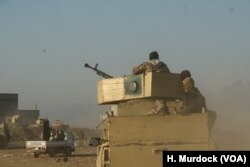 On the outskirts of and IS-held village, dozens of kilometers from Mosul, Iraqi soldiers fire mortars at IS, while sniper fire wizes back at the Iraqi Army base in Ganus al-Ulya, Iraq, Dec. 10, 2016.