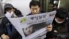  FILE - A South Korean man reads a newspaper with the headline reporting North Korea's rocket launch while traveling on a subway in Seoul, South Korea, Dec. 13, 2012.