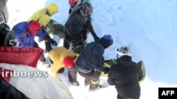 A screen grab from footage broadcast on Iranian state TV IRIB on Dec. 26, 2020, shows a search-and-rescue operation being conducted after a number of climbers were found dead because of avalanches north of Tehran. Several climbers remained missing.