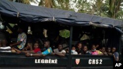 Opposition supporters are seen in a police truck in Abidjan, Ivory Coast, Nov. 3, 2020, during a protest challenging the results of a controversial Oct. 31 election.