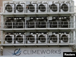 FILE - A facility for capturing CO2 from air of Swiss Climeworks AG is placed on the roof of a waste incinerating plant in Hinwil, Switzerland, July 18, 2017.