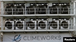 FILE - A facility for capturing CO2 from air of Swiss Climeworks AG is placed on the roof of a waste incinerating plant in Hinwil, Switzerland, July 18, 2017. 