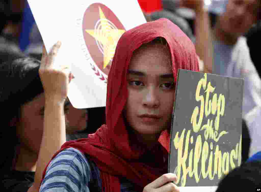 Students display placards during a rally near the Presidential Palace to protest reported military&#39;s &quot;red-tagging&quot; of Metro Manila schools and universities and linking them to an alleged plot to topple President Rodrigo Duterte known as &quot;Red October&quot;.