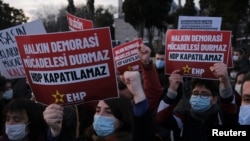 People shout slogans during a demonstration to protest against the court case launched for closure of the pro-Kurdish opposition Peoples' Democratic Party in Istanbul, Turkey, March 18, 2021.