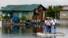 Health care workers ride on a makeshift raft during the house to house vaccination of bedridden citizens for the coronavirus disease, in Valenzuela City, Metro Manila, Philippines.