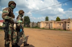 Soldiers patrol the streets of Soweto, South Africa, April 23, 2020, as the country remains in lockdown for a fourth week in a bid to combat the spread of the coronavirus.