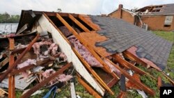 A roof a home that was blown off a home rests on the ground in Hamilton, Miss., after after a deadly storm moved through the area, April 14, 2019. 