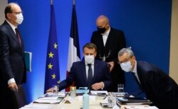 Presiden Prancis Emmanuel Macron (tengah) diapit oleh Perdana Menteri Prancis Jean Castex (kiri) dan Sekretaris Jenderal Istana Elysee Alexis Kohler (kanan) memulai pertemuan keamanan nasional untuk membahas spyware Pegasus. (Foto: AFP)