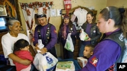 A group of Mexican women hand out aid in a low-income Ciudad Juarez neighborhood on Jan 23 201