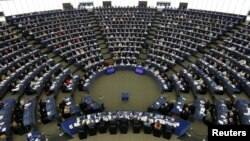 FILE - Members of the European Parliament take part in a voting session at the European Parliament in Strasbourg, France, April 5, 2017. 
