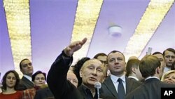 Russian Prime Minister and presidential candidate Vladimir Putin, center, greets his supporters at his election headquarters in Krasnoyarsk, Russia, Monday, March 5, 2012. (AP Photo/Alexander Zemlianichenko)